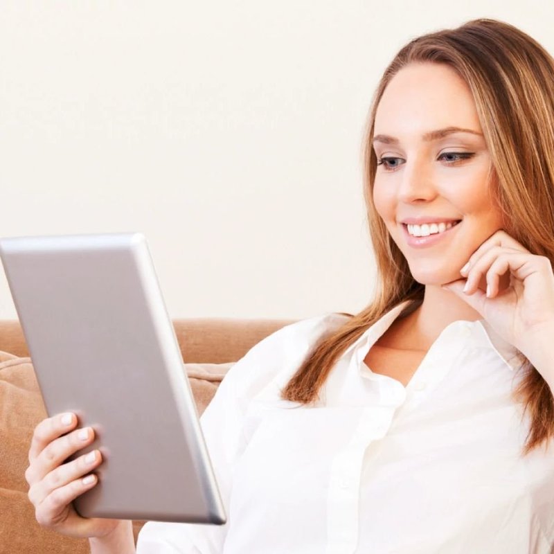 Woman On Tablet - Fast and easy financing with approved credit from Northcraft Flooring & Design in Lee's Summit, MO
