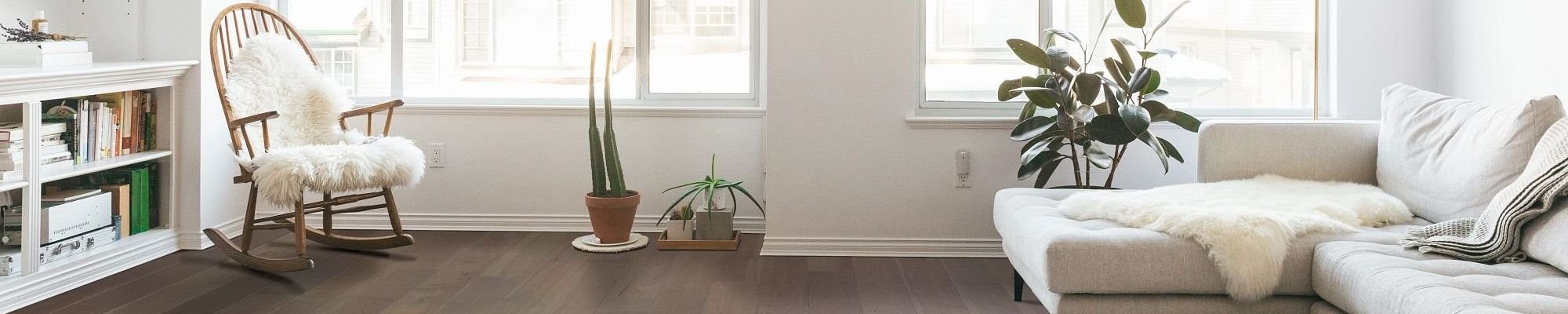 white furniture in a living room with hardwood flooring from Northcraft Flooring & Design in Lee's Summit, MO