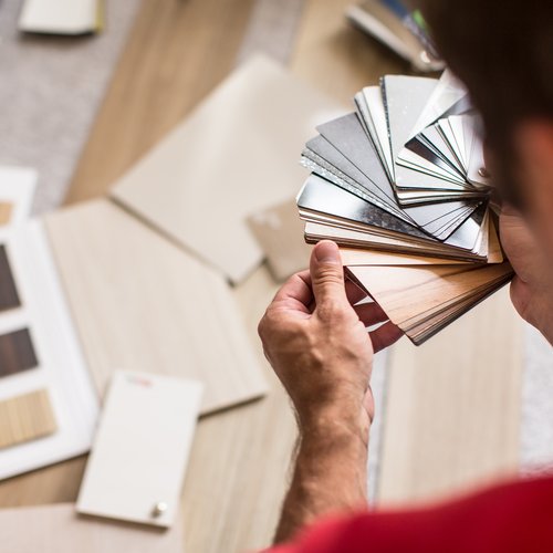 Person looking at swatches from Northcraft Flooring & Design in Raytown, MO