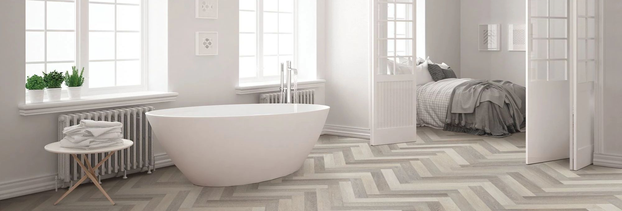 Bathroom with a white bathtub and wood-look luxury vinyl flooring from Northcraft Flooring & Design in Raytown, MO